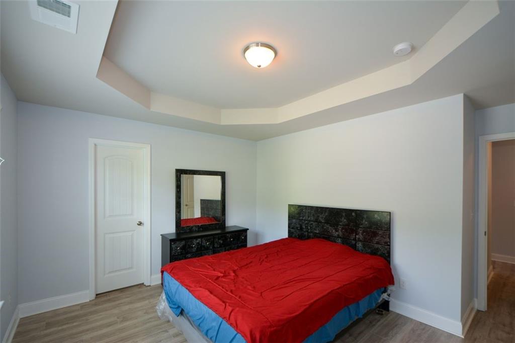 917 Revere Way Hampton, GA 30228 - Photo 20 of 25 a bedroom with a bed and a flat screen tv