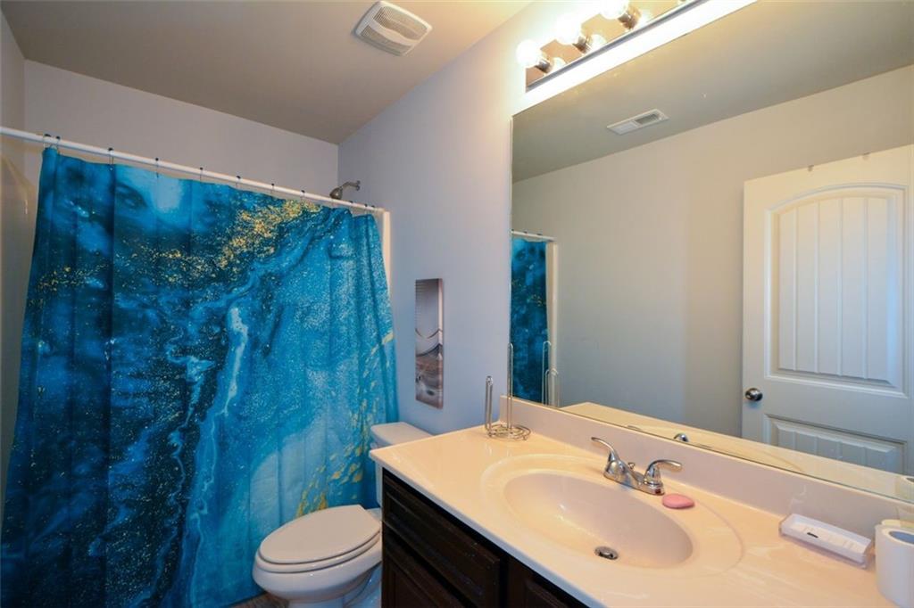 917 Revere Way Hampton, GA 30228 - Photo 21 of 25 a bathroom with a sink toilet and shower