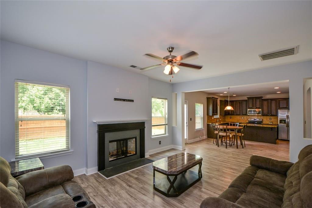 917 Revere Way Hampton, GA 30228 - Photo 10 of 25 a living room with furniture a fireplace and a window
