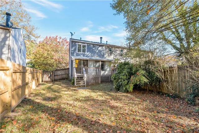 a view of a house with a yard and pathway