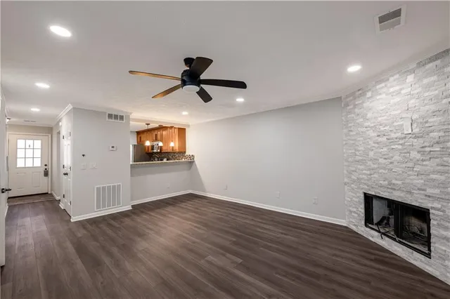 a view of empty room with wooden floor and fireplace