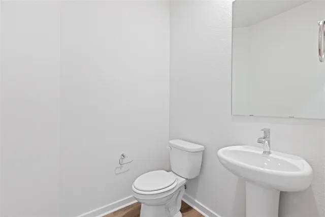 a bathroom with a sink a toilet and mirror