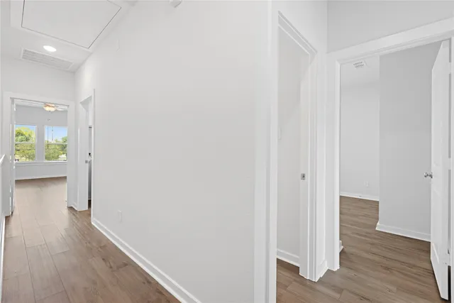 a view of a hallway with wooden floor