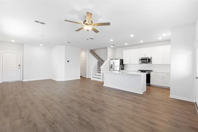 a view of kitchen with cabinets and wooden floor