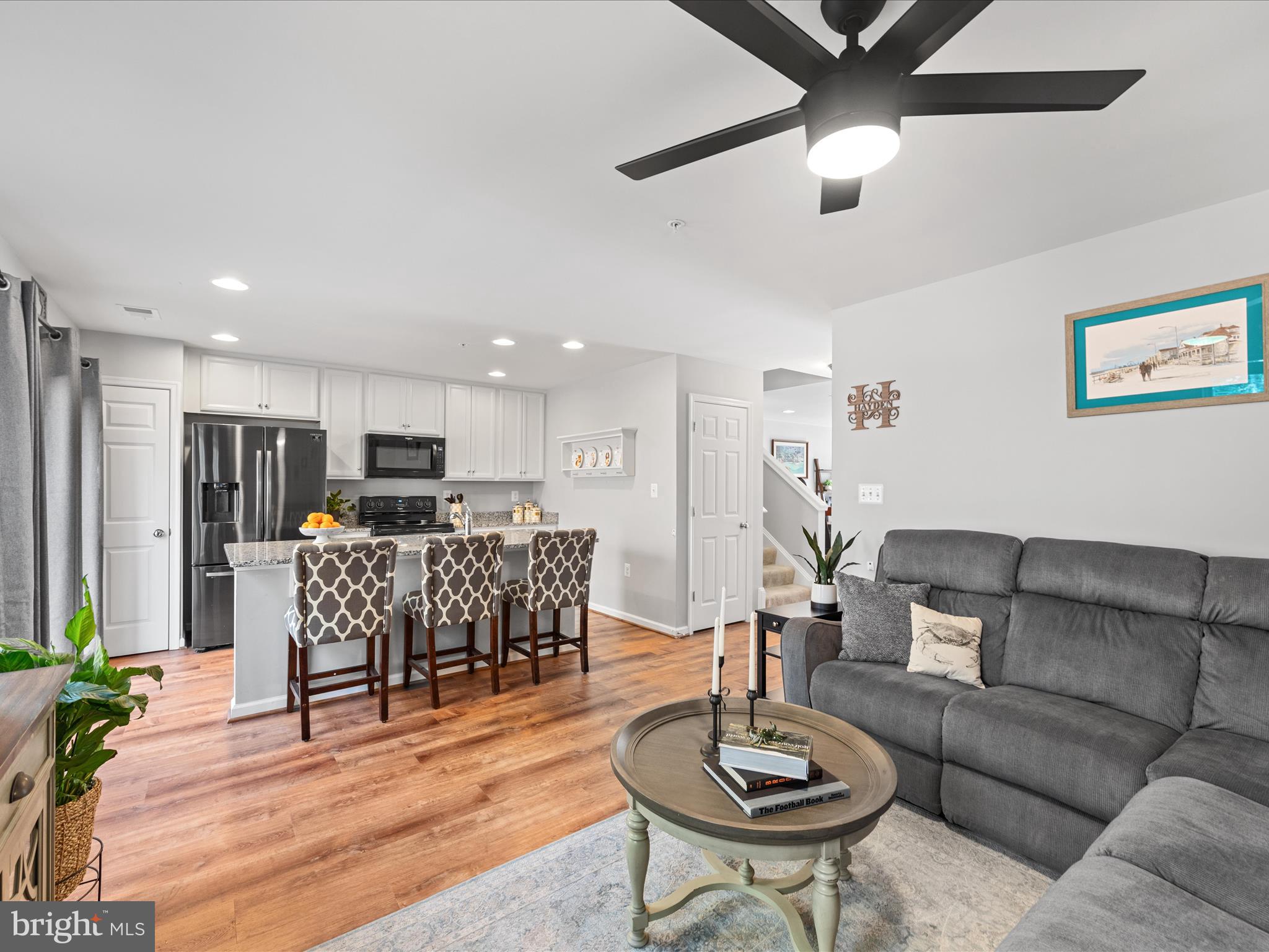 165 Intrepid Lane Berlin, MD 21811 - Photo 12 of 46 a living room with furniture kitchen view and a wooden floor