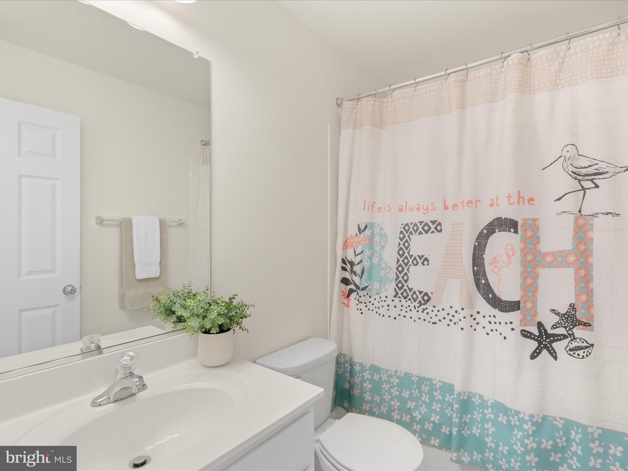 165 Intrepid Lane Berlin, MD 21811 - Photo 25 of 46 a bathroom with a sink vanity mirror and toilet