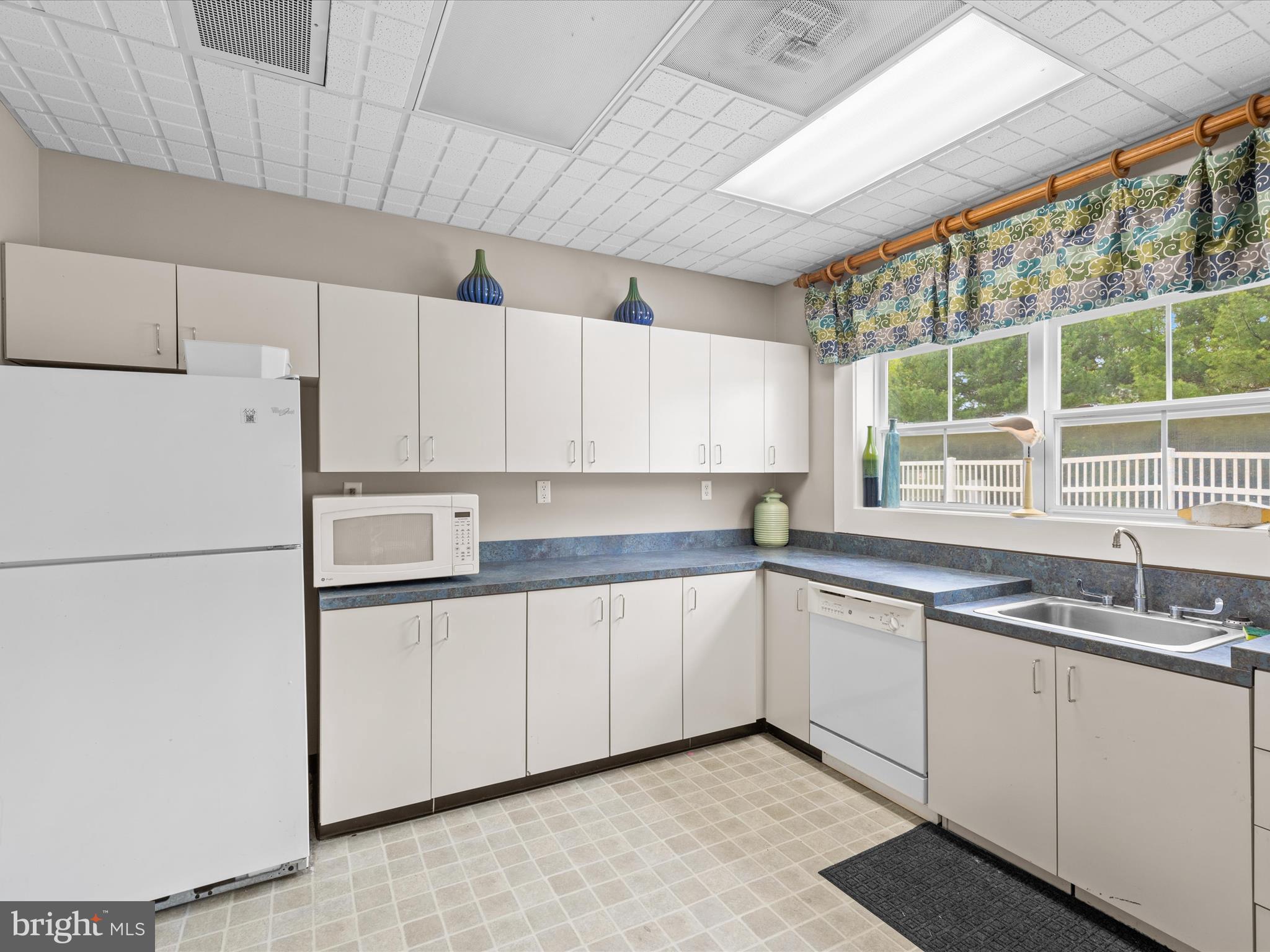 165 Intrepid Lane Berlin, MD 21811 - Photo 44 of 46 a kitchen with a sink and white cabinets