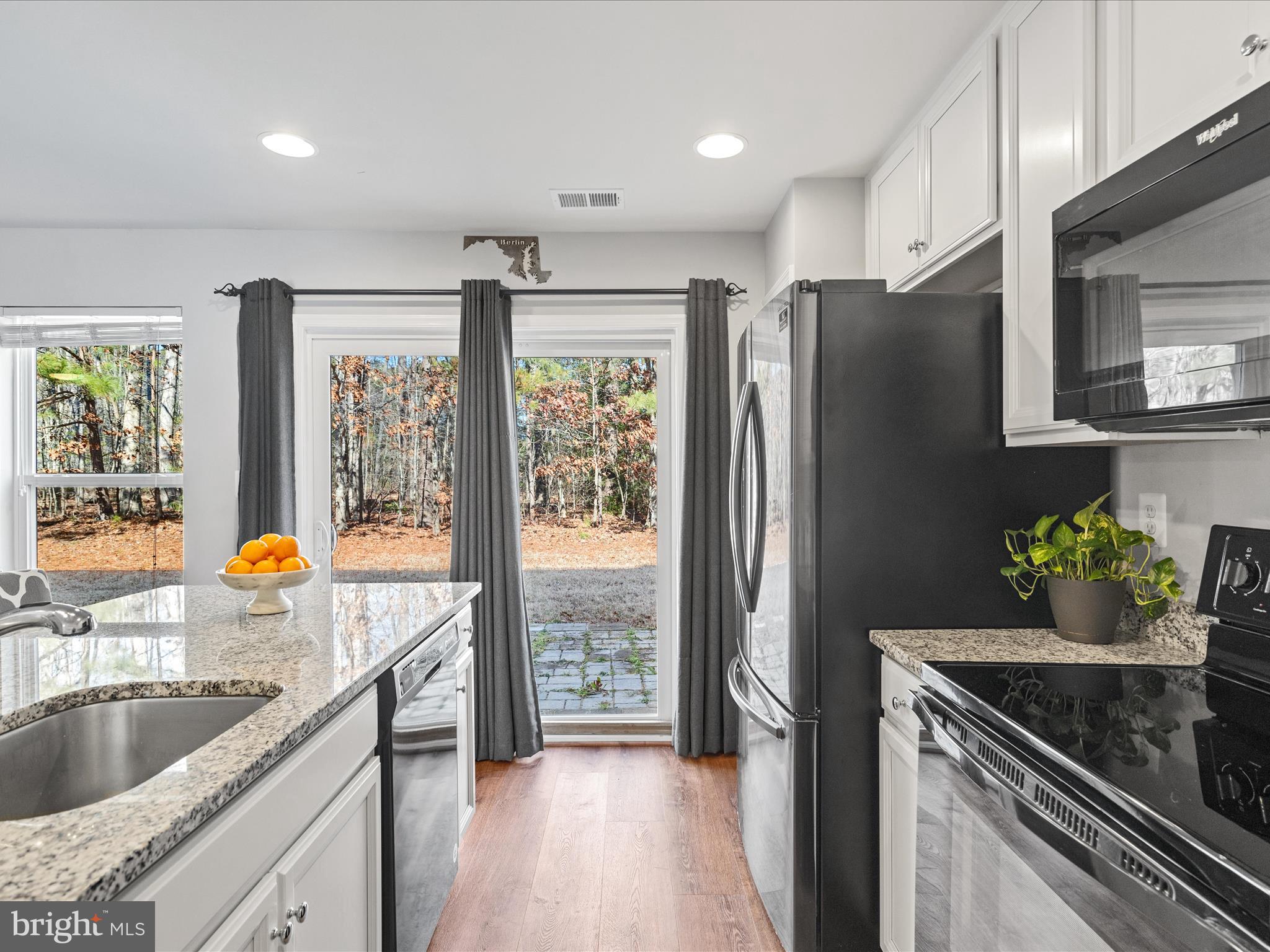 165 Intrepid Lane Berlin, MD 21811 - Photo 10 of 46 a kitchen with stainless steel appliances granite countertop a refrigerator and a sink