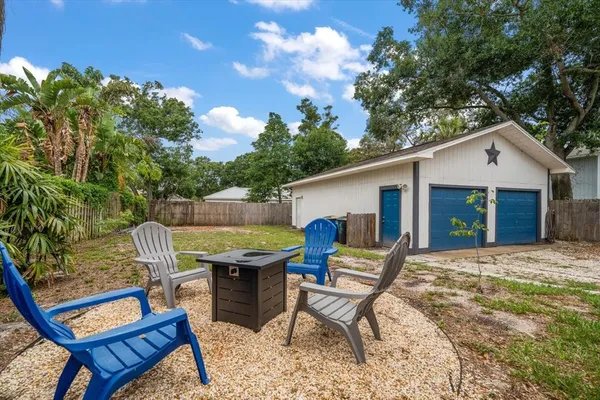 a view of a house with backyard and sitting area