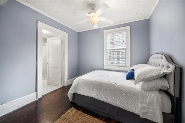 a bed sitting in a bedroom next to a window