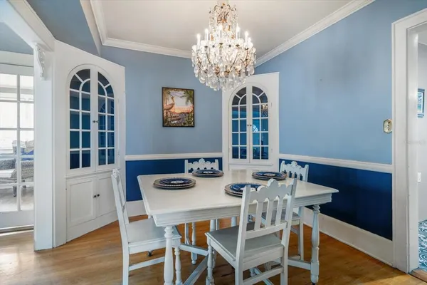 a view of a dining room with furniture and chandelier