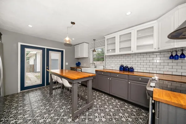 a kitchen with a sink a counter space and stainless steel appliances