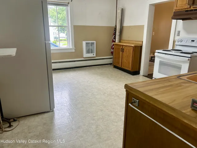 a kitchen with refrigerator and cabinets
