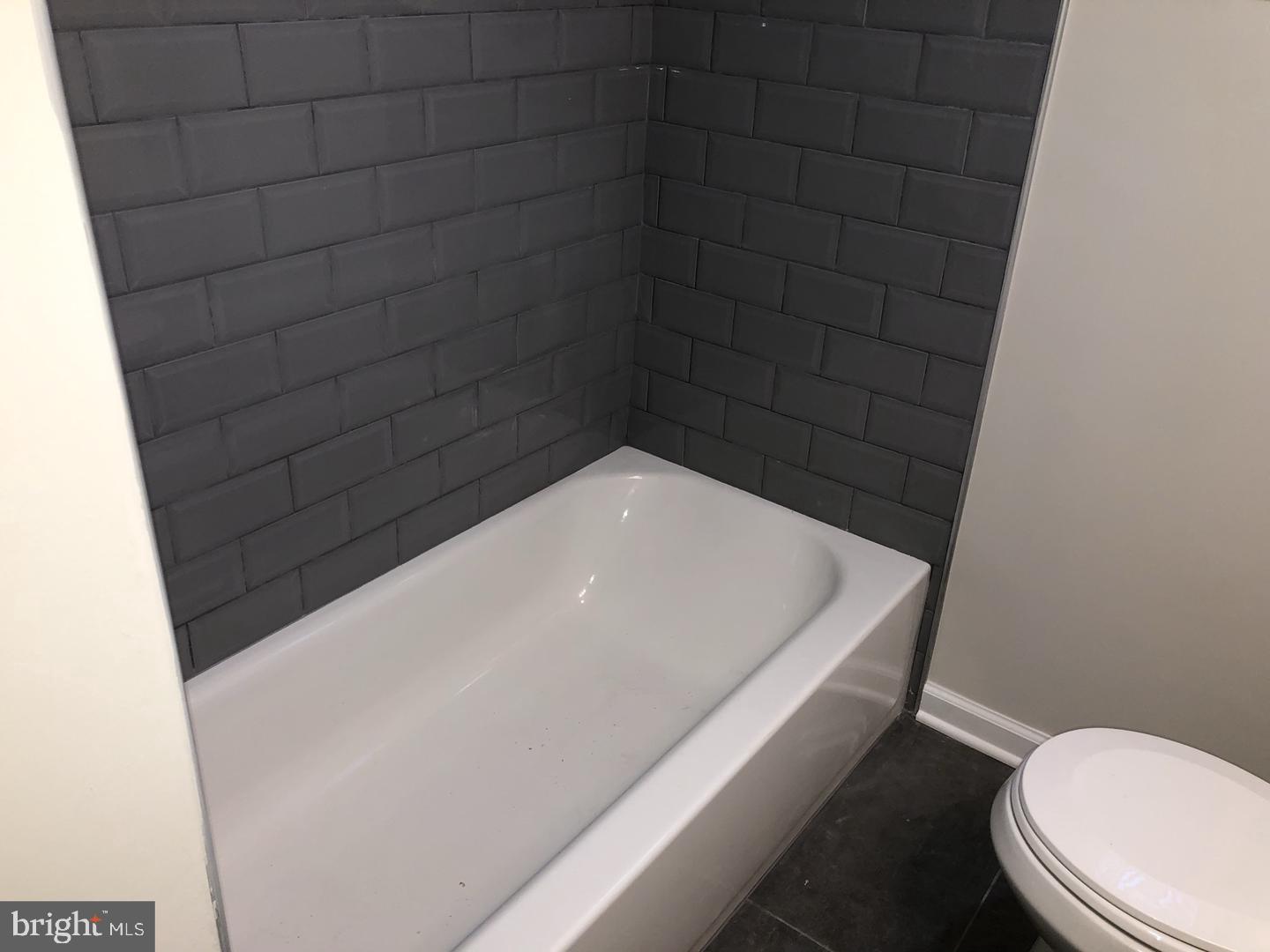 504 Bridge Street Beverly, NJ 08010 - Photo 8 of 13 a bathroom with a white toilet and a bathtub