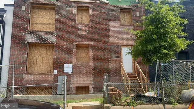 a front view of a house with a iron gate