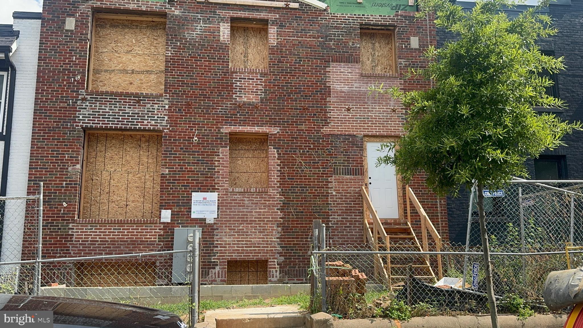 a front view of a house with a iron gate