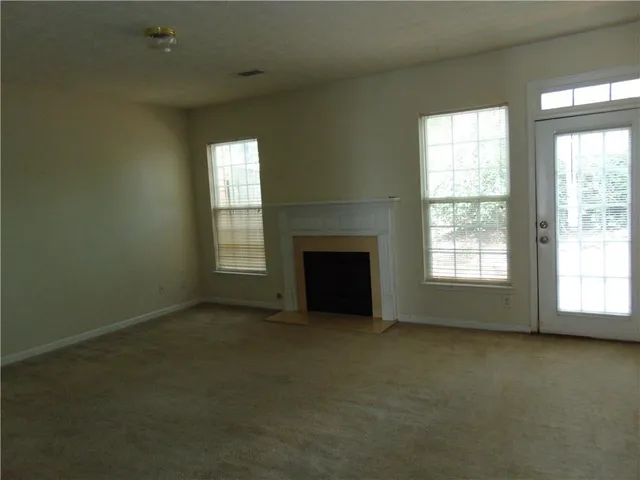 a view of empty room with a fireplace