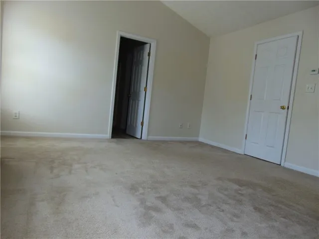 a view of an empty room and closet area