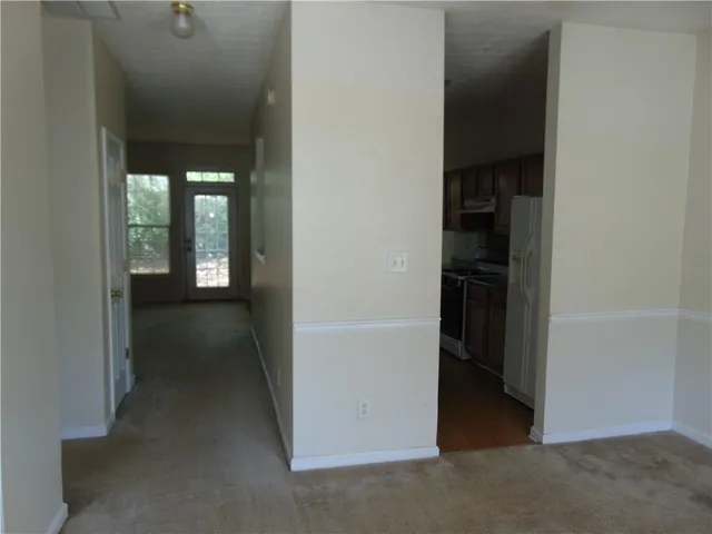 a kitchen with granite countertop a stove and a refrigerator