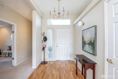 a bedroom with a large bed and a painting on the wall
