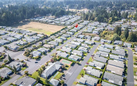 a swimming pool view with a seating space