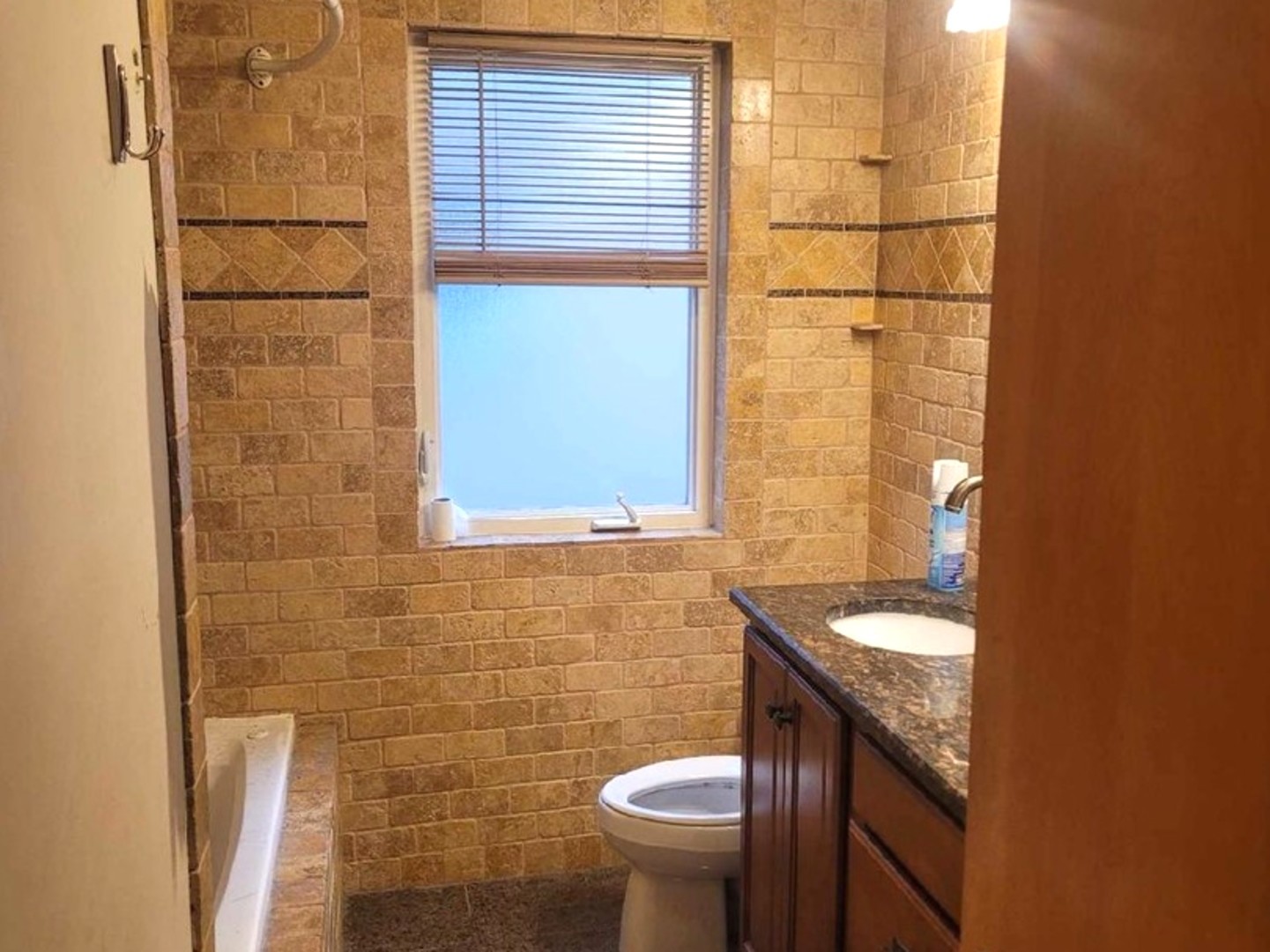 4144 North Parkside Avenue, Unit 1 Chicago, IL 60634 - Photo 3 of 3 a bathroom with a granite countertop toilet and a sink