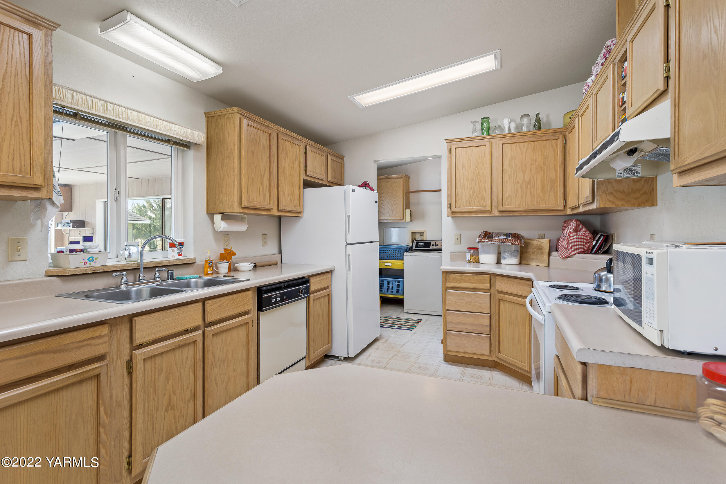 1607 Beaudry Road Yakima, WA 98901 - Photo 12 of 45 a kitchen with cabinets appliances a sink and a window