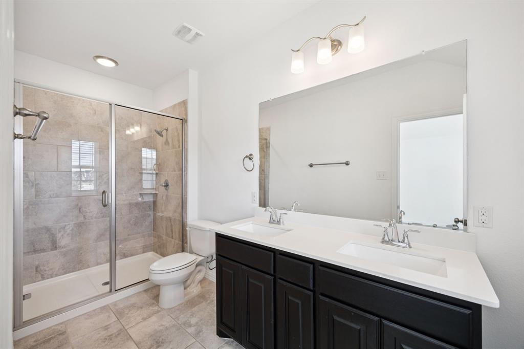 964 Emil Place Allen, TX 75013 - Photo 19 of 25 a bathroom with a double vanity sink toilet and shower