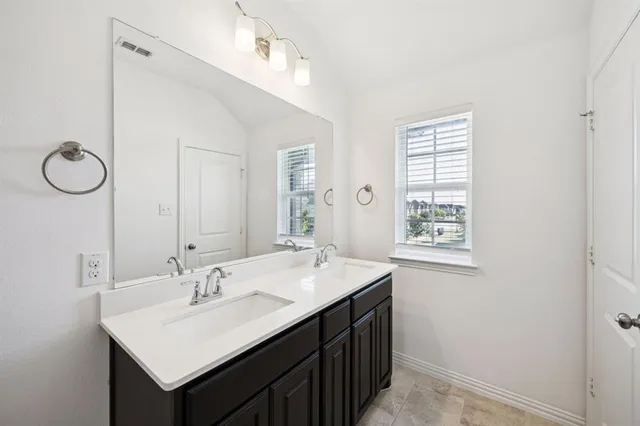 a bathroom with a sink vanity and a mirror