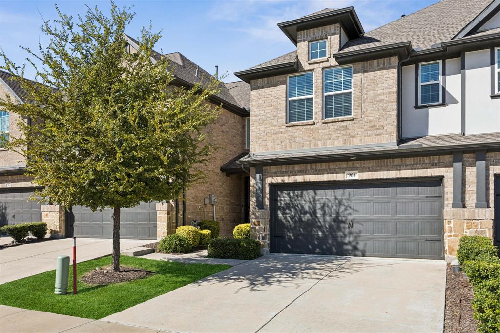 964 Emil Place Allen, TX 75013 - Photo 2 of 25 a front view of a house with garden