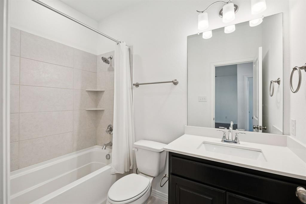 964 Emil Place Allen, TX 75013 - Photo 23 of 25 a bathroom with a sink a toilet and shower