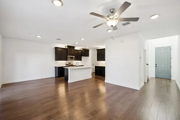 a view of kitchen with cabinets microwave and stove
