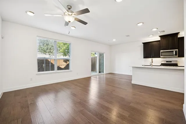 a view of kitchen with microwave and wooden floor