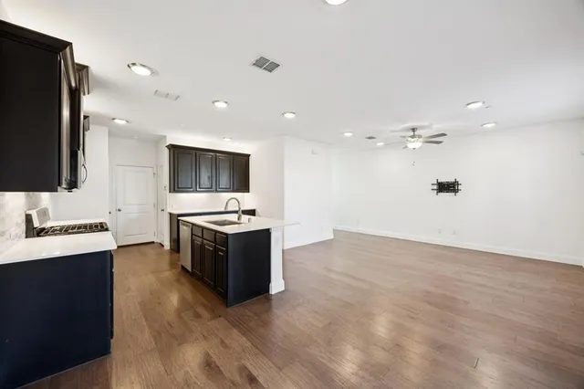 a large kitchen with a sink and a stove top oven