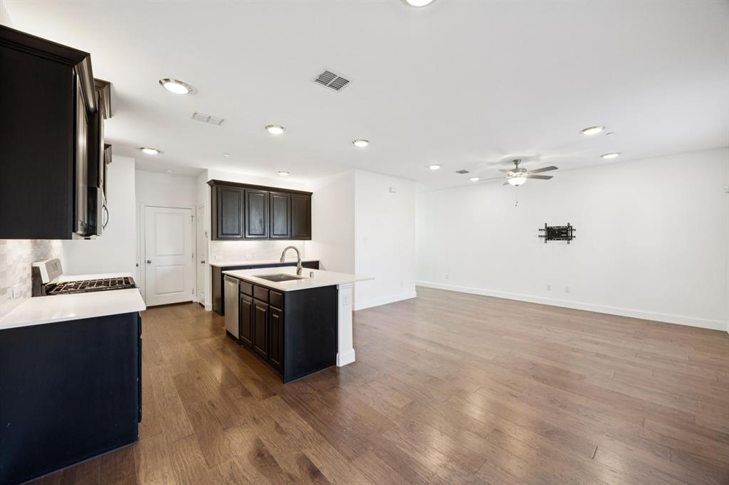 964 Emil Place Allen, TX 75013 - Photo 7 of 25 a large kitchen with a sink and a stove top oven