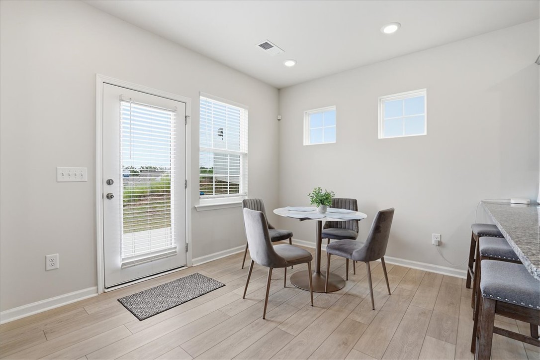 365 Sliding Rock Drive Pendleton, SC 29670 - Photo 9 of 46 A well-lit dining area featuring light wood flooring and a modern breakfast bar.