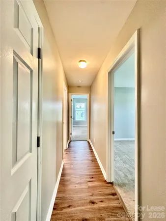 a view of hallway with wooden floor