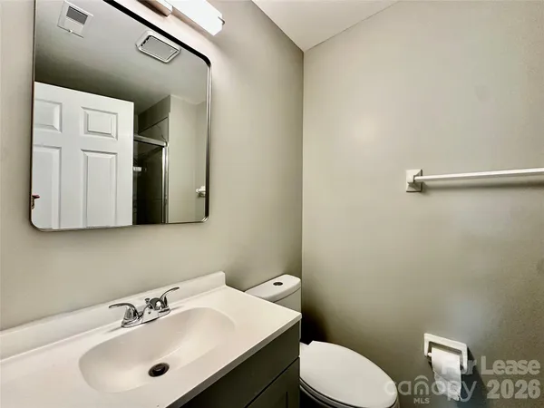 a bathroom with a sink mirror and toilet