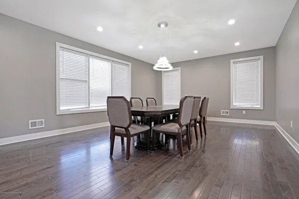 a view of a dining room with furniture and wooden floor