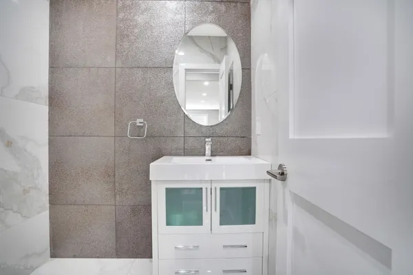 a bathroom with a sink a mirror and a shower