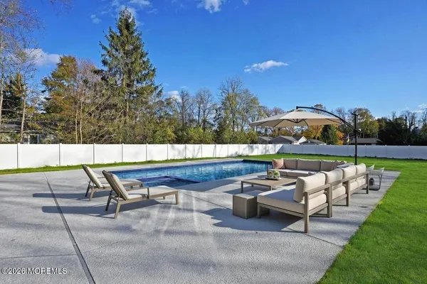 a view of a chairs and table in patio with a lake view