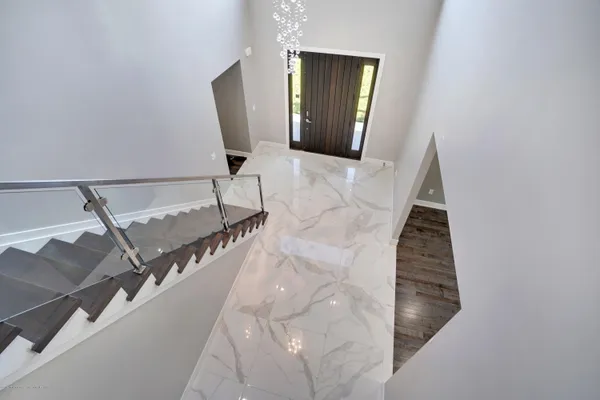 a view of a livingroom with wooden floor and staircase