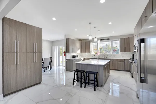 a kitchen with cabinets and refrigerator