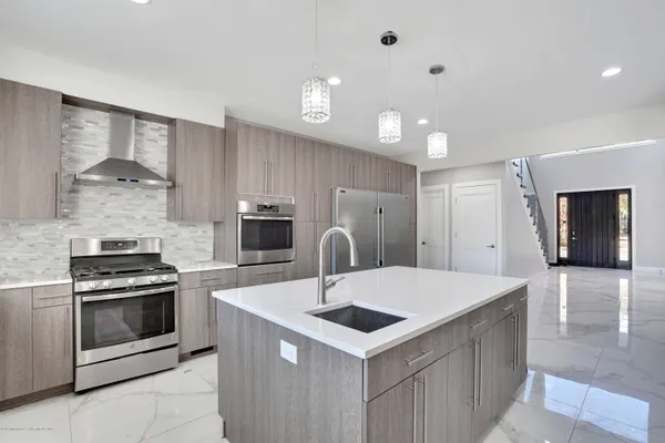 a kitchen with a stove a sink and a refrigerator