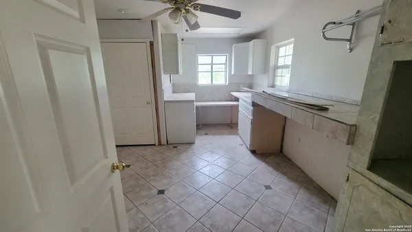 a view of an empty room with a fireplace and a window