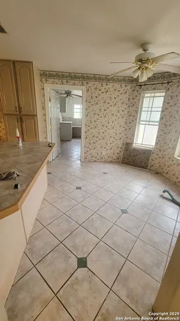 a large kitchen with a sink and cabinets