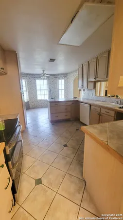 a bathroom with a sink toilet a mirror and window