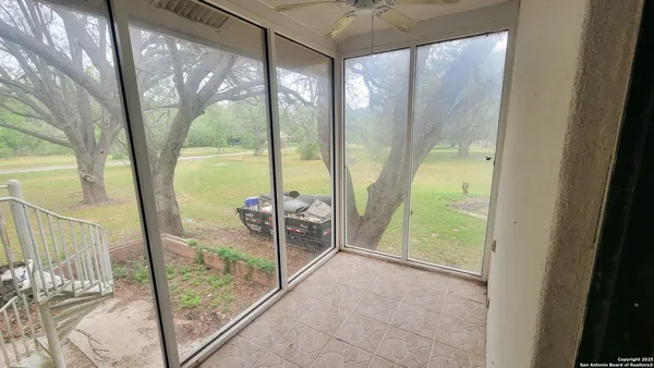 a view of an empty room with a floor to ceiling window