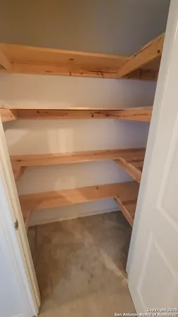 a view of a storage & utility room with a window