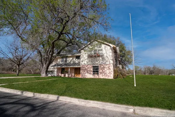 a view of a house with a yard